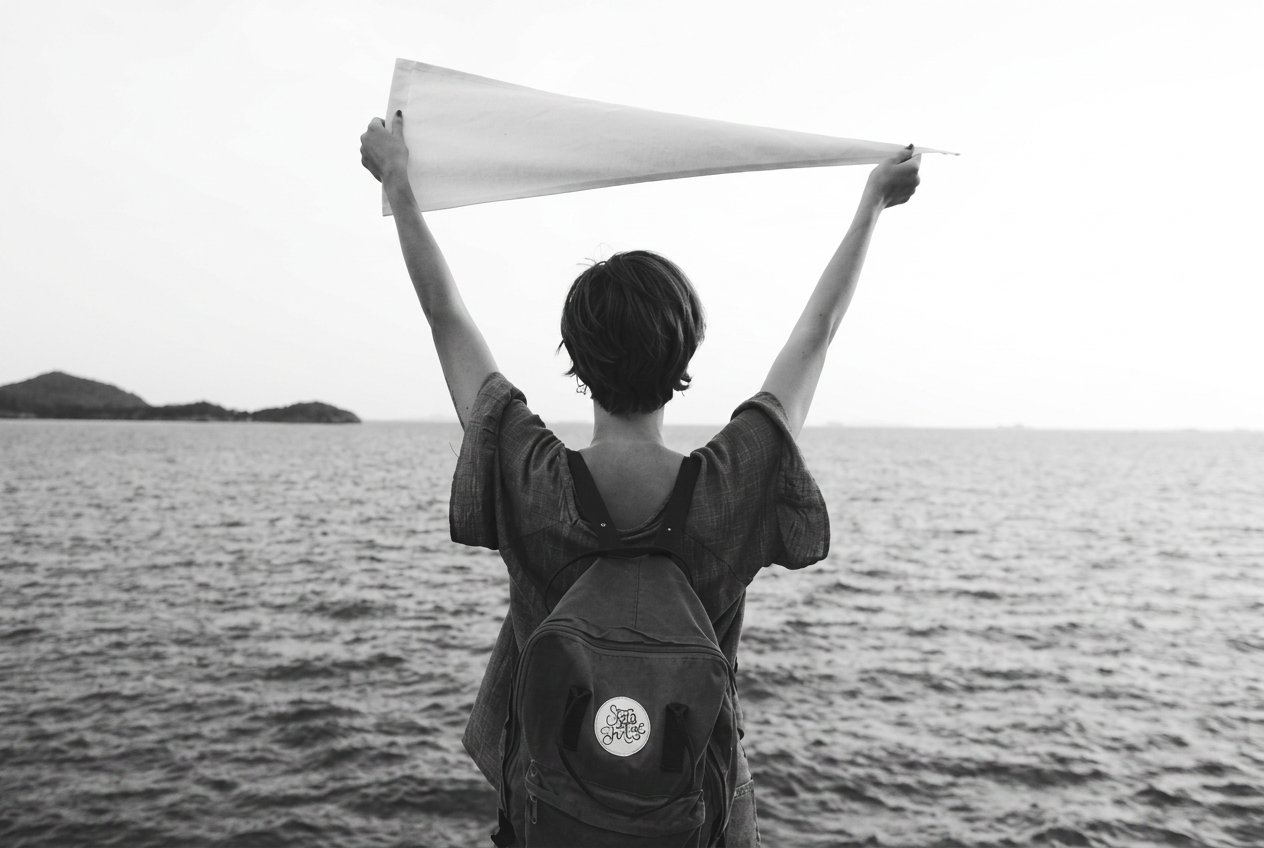 Person with arms raised outdoors